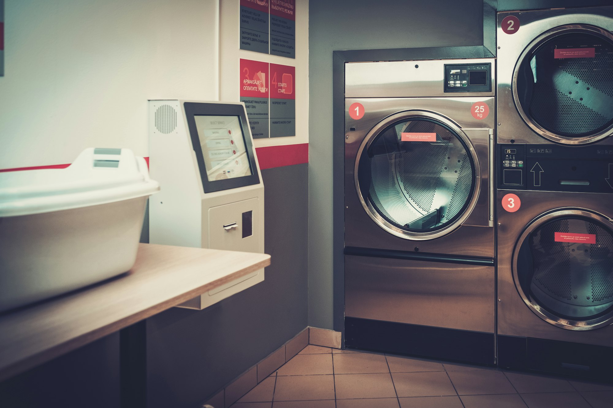 Laundry machines at laundromat shop.